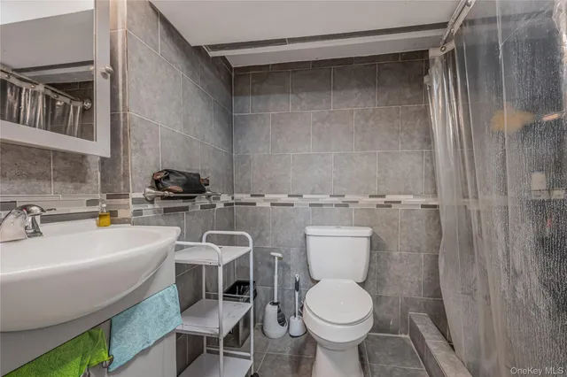 a bathroom with a sink toilet and a mirror