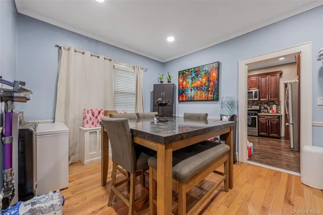 a view of a kitchen area with furniture and wooden floor