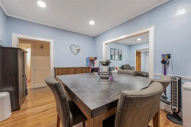 a dining room with furniture and wooden floor