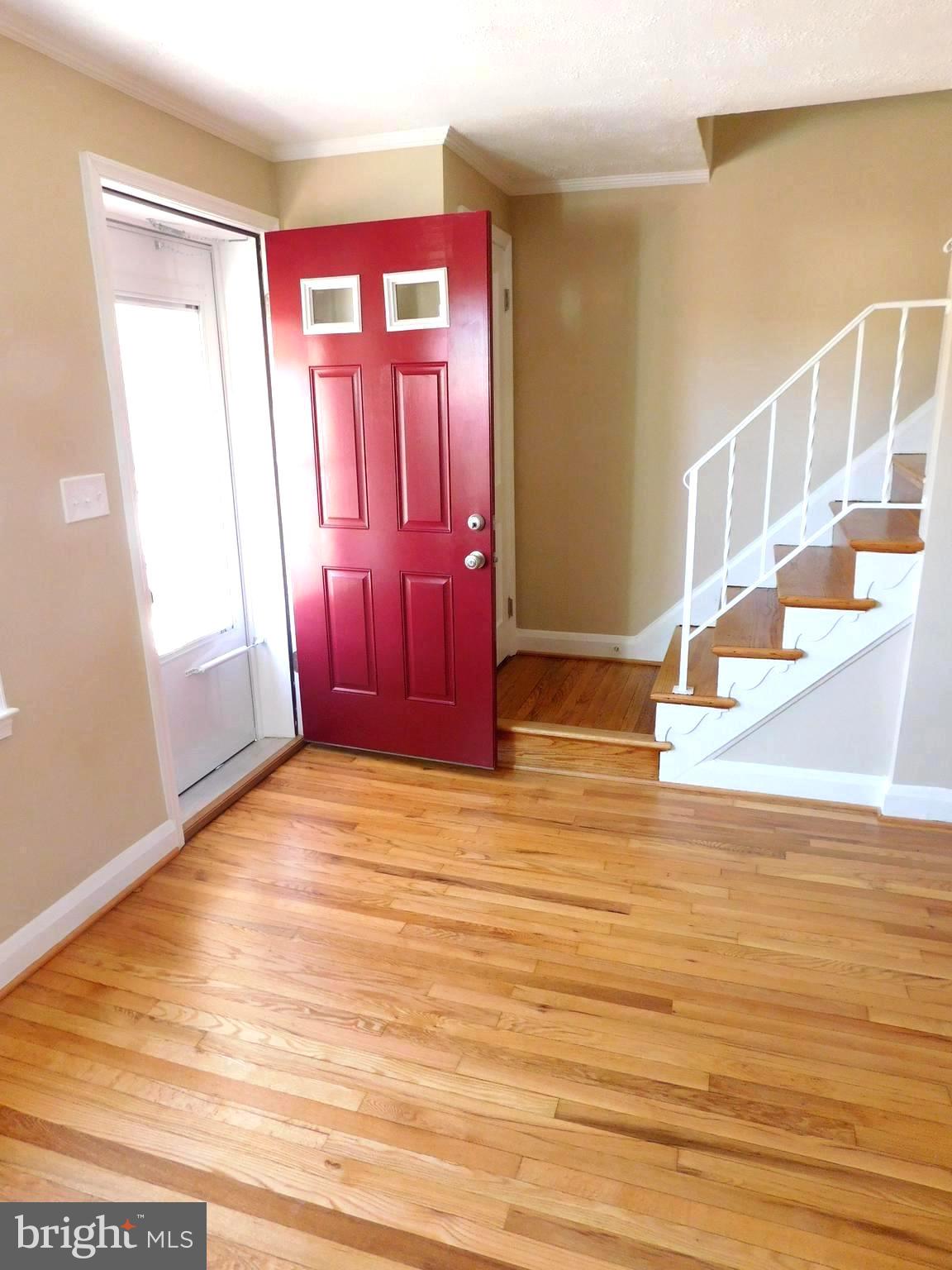 4012 Rexmere Road Baltimore, MD 21218 - Photo 2 of 29 a view of an empty room with wooden floor and a window