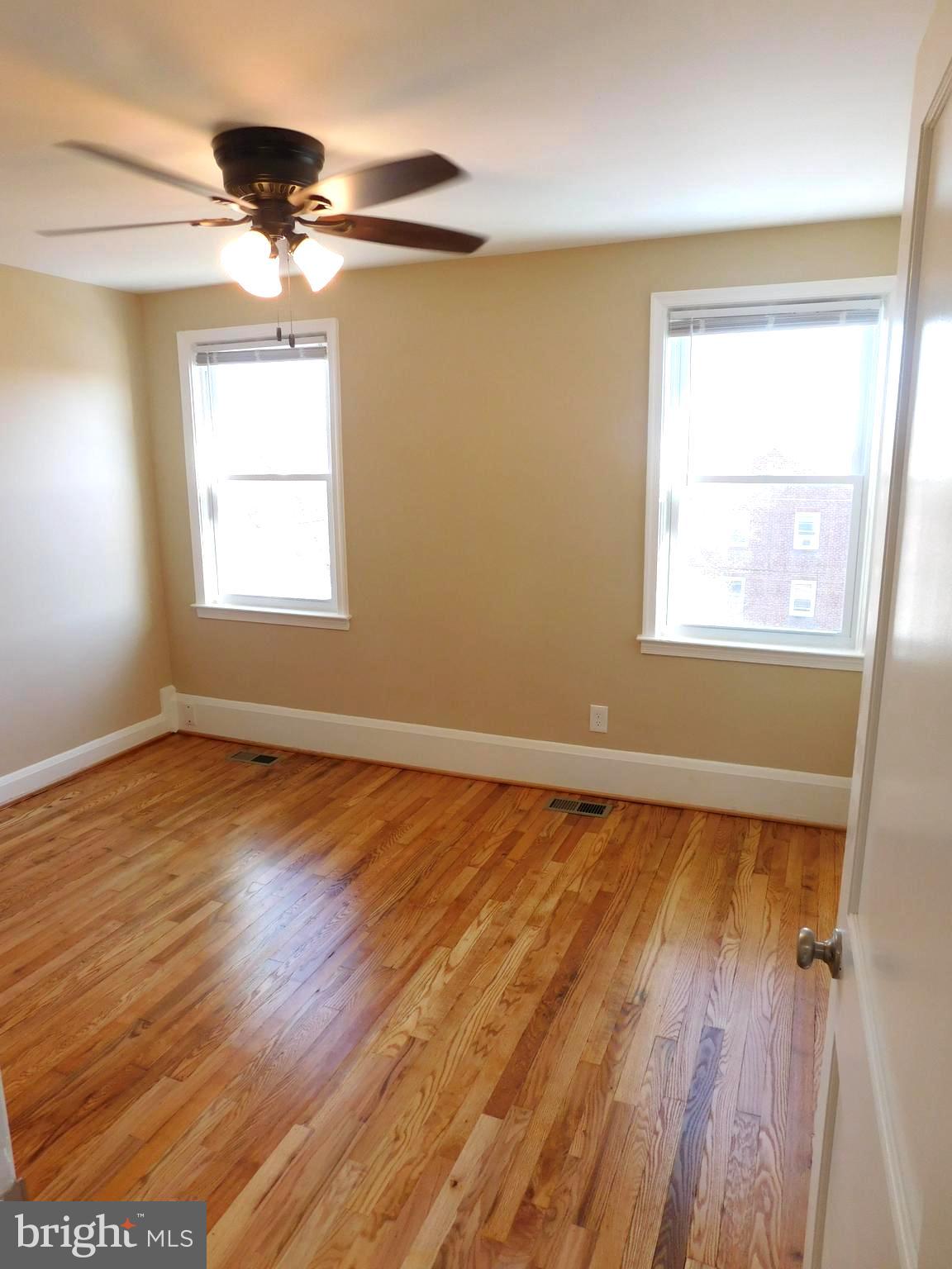 4012 Rexmere Road Baltimore, MD 21218 - Photo 12 of 29 a view of an empty room with wooden floor and a window