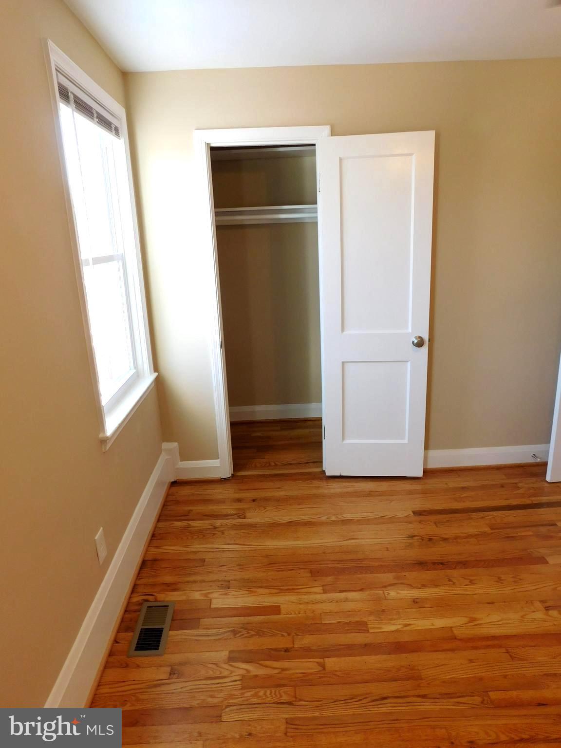 4012 Rexmere Road Baltimore, MD 21218 - Photo 14 of 29 a view of an empty room with closet and wooden floor