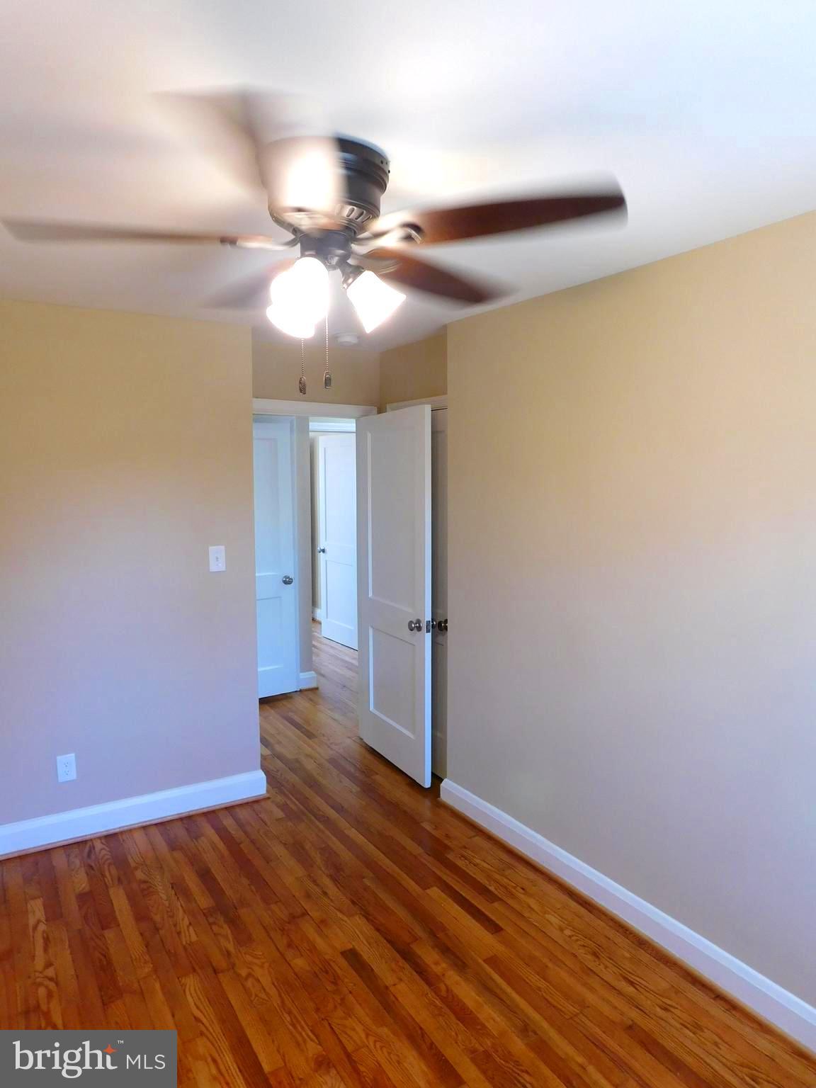 4012 Rexmere Road Baltimore, MD 21218 - Photo 16 of 29 a view of an empty room with wooden floor