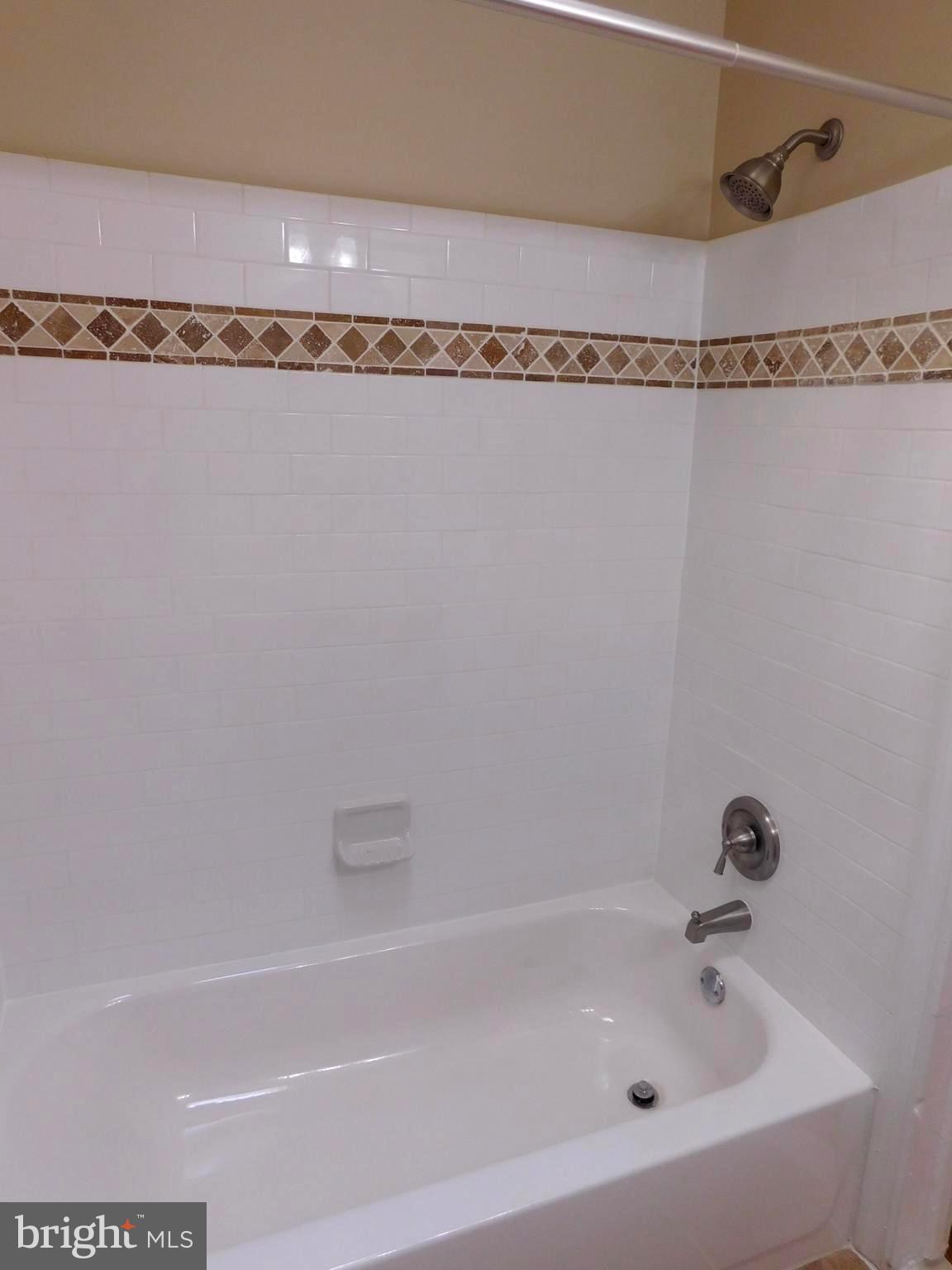 4012 Rexmere Road Baltimore, MD 21218 - Photo 22 of 29 a bathroom with a bathtub and a shower