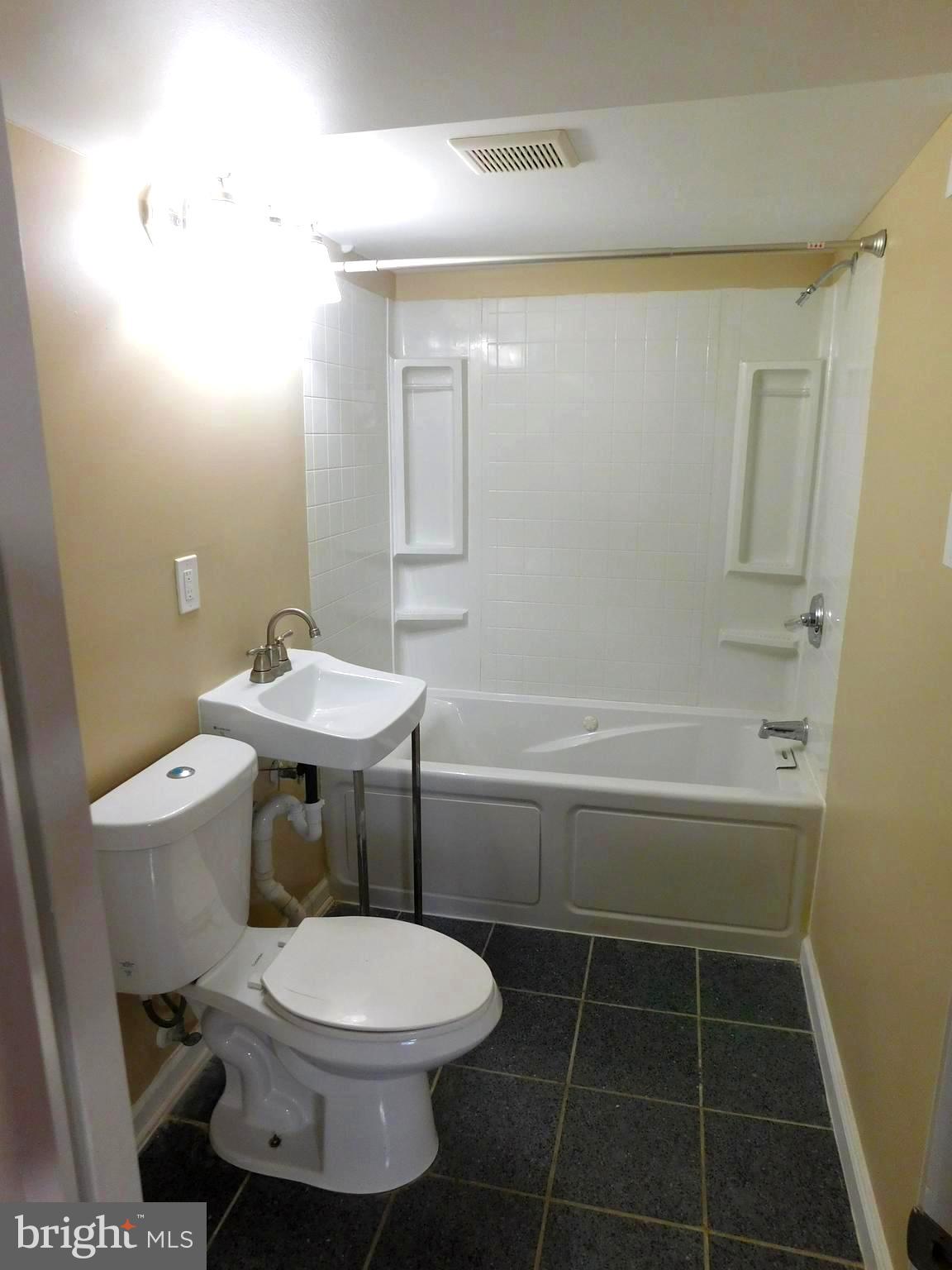 4012 Rexmere Road Baltimore, MD 21218 - Photo 26 of 29 a bathroom with a toilet a sink and bathtub