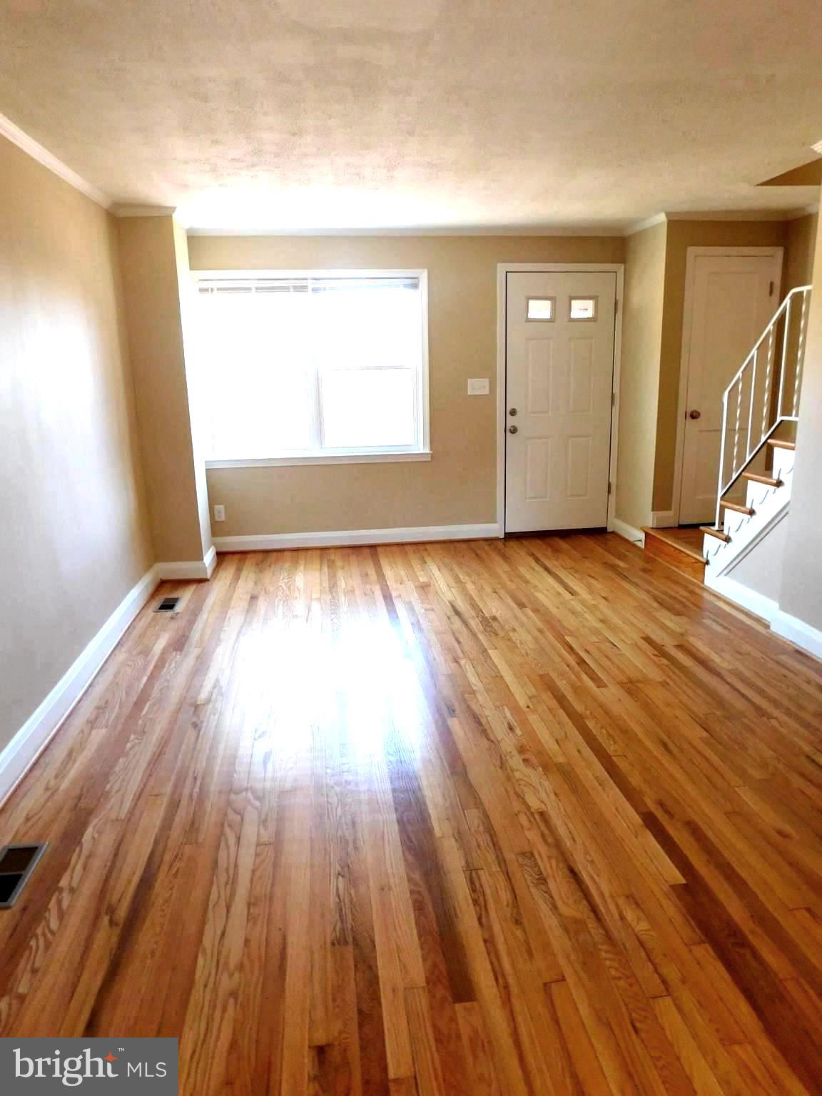 4012 Rexmere Road Baltimore, MD 21218 - Photo 4 of 29 wooden floor in an empty room with a window