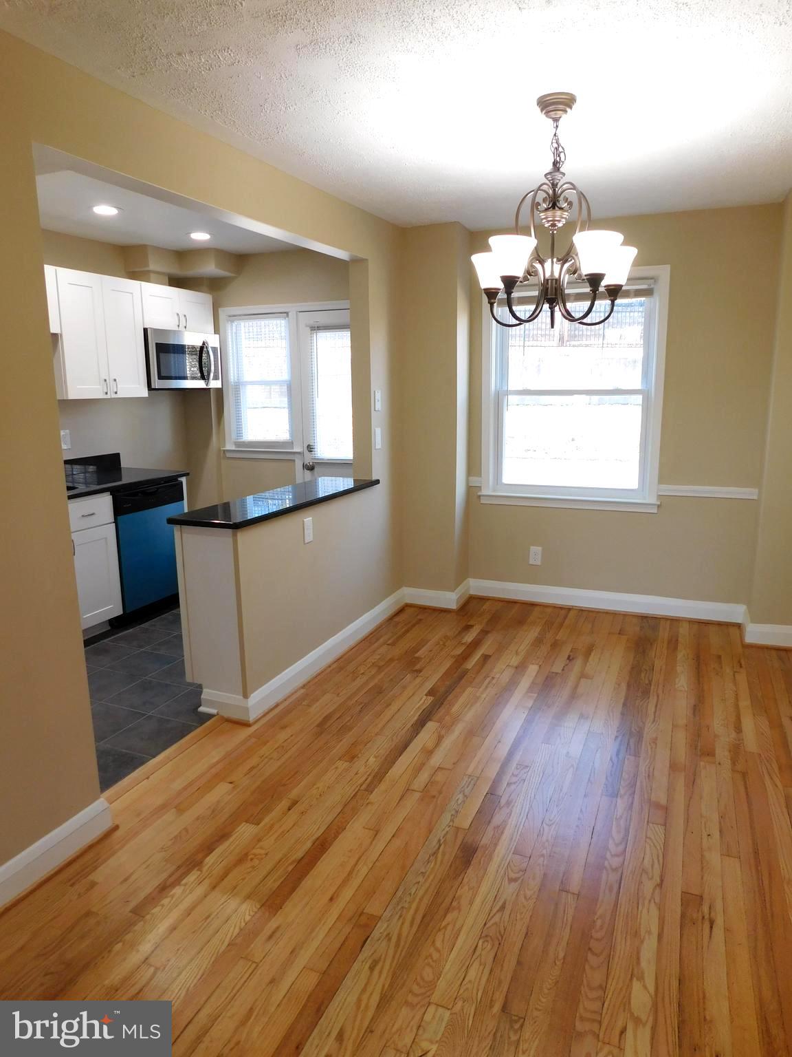 4012 Rexmere Road Baltimore, MD 21218 - Photo 6 of 29 a kitchen with stainless steel appliances wooden floors and stove