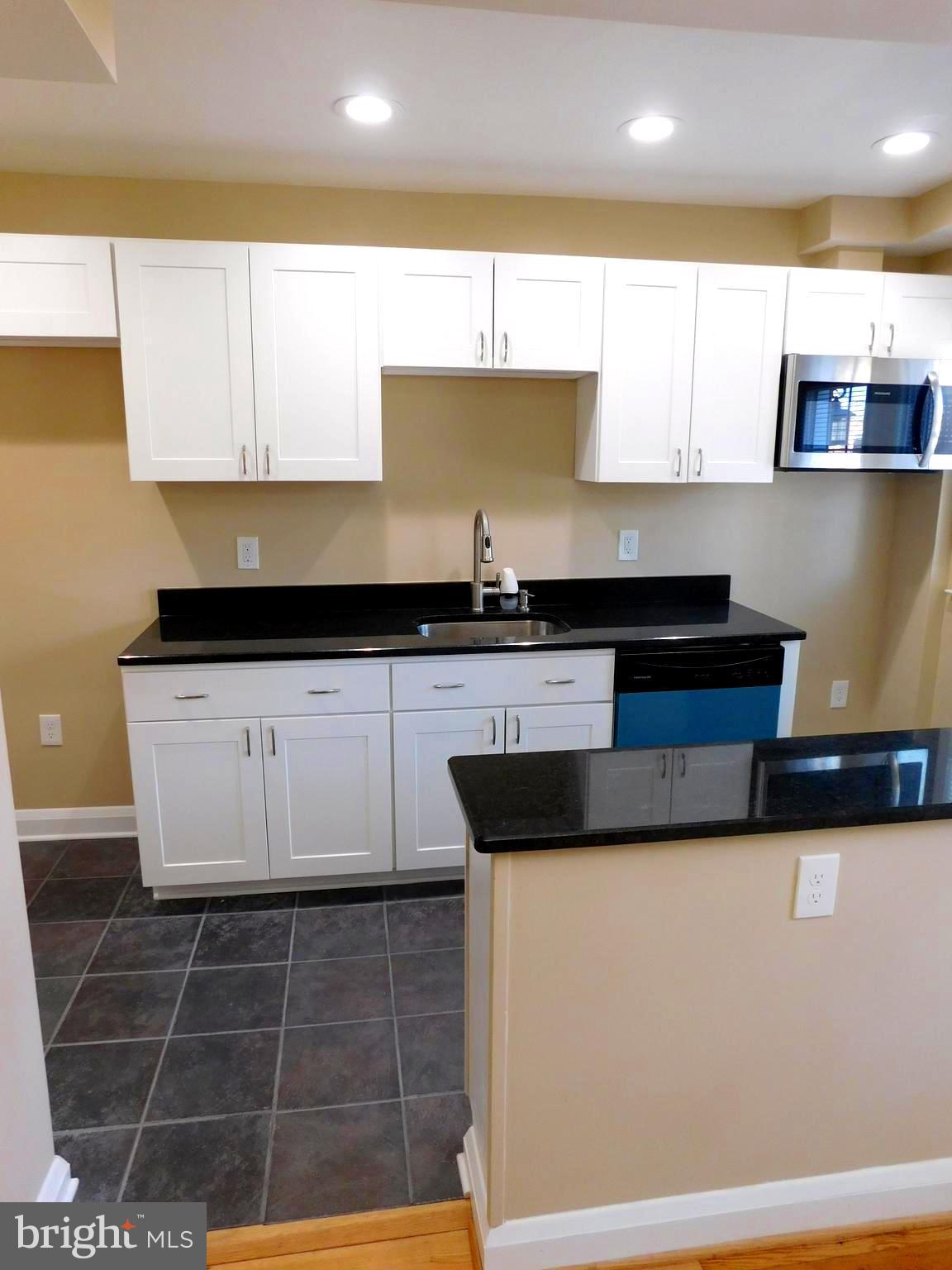 4012 Rexmere Road Baltimore, MD 21218 - Photo 8 of 29 a kitchen with granite countertop a sink a stove and cabinets