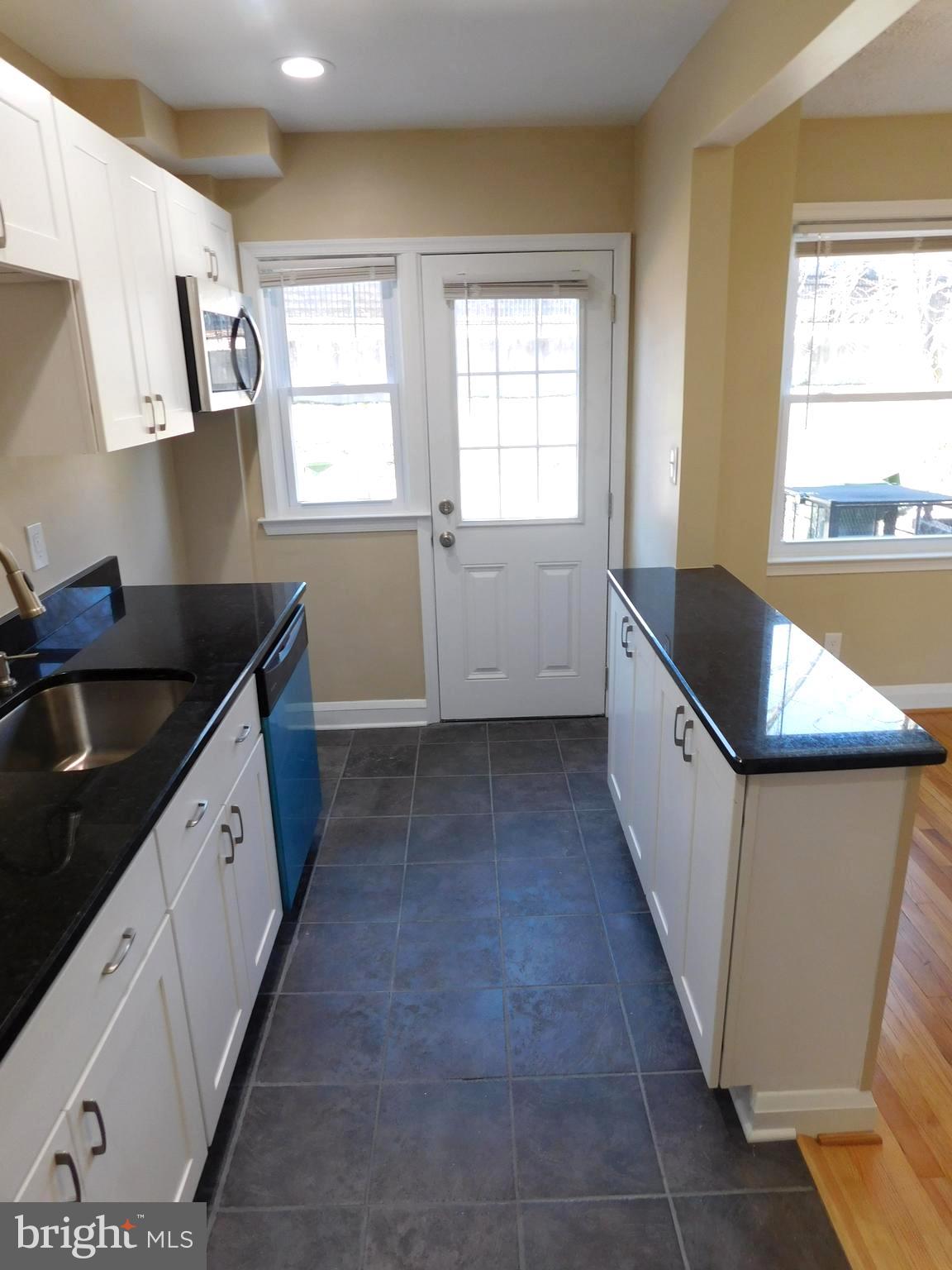 4012 Rexmere Road Baltimore, MD 21218 - Photo 9 of 29 a kitchen with a sink a stove and cabinets