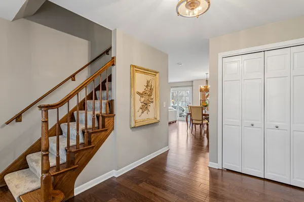 a view of entryway with wooden floor and stairs