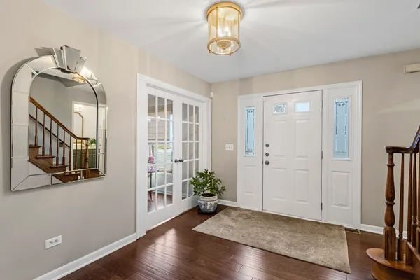 a view of an entryway with wooden floor