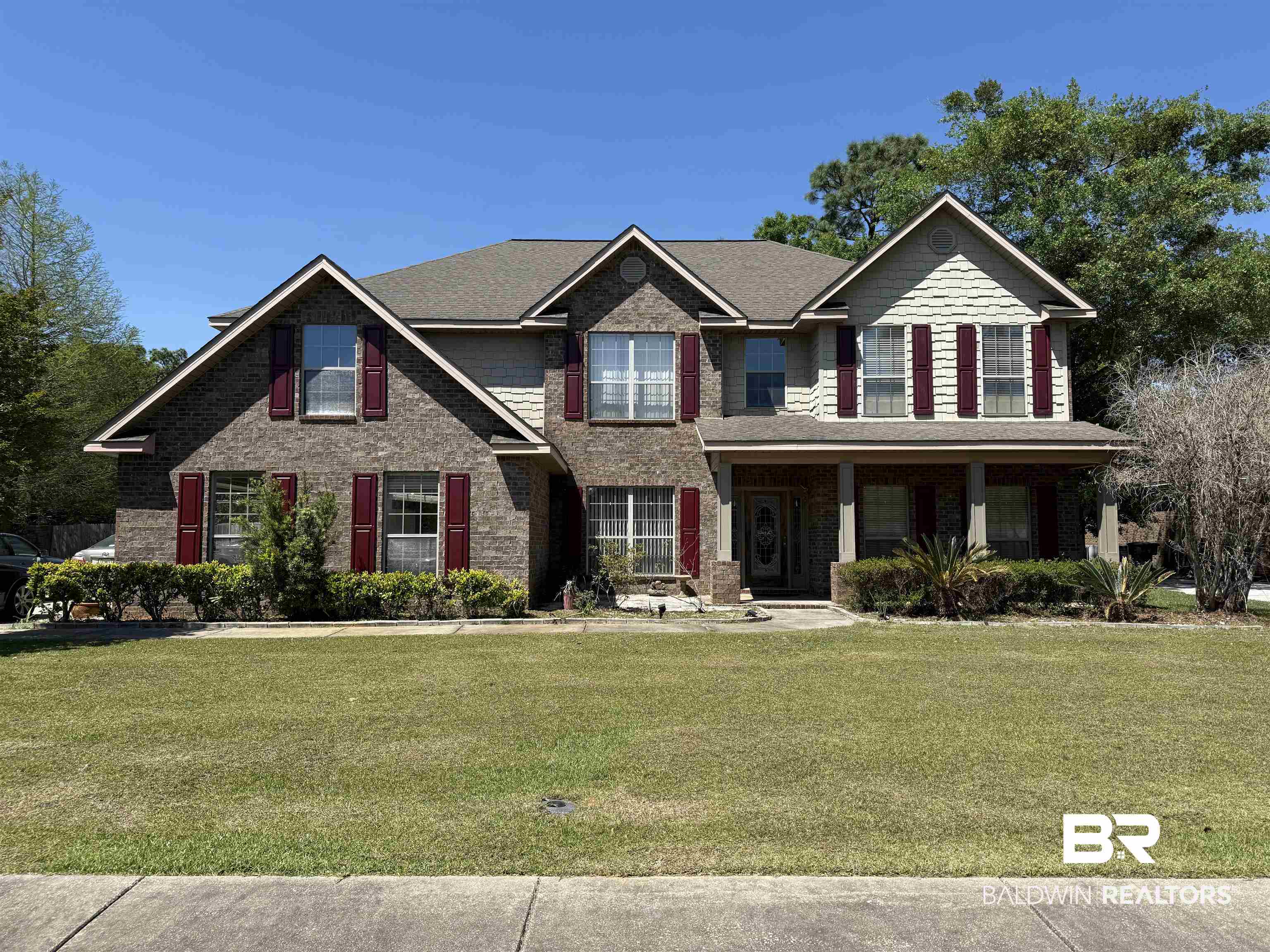 9023 Krystal Ridge Court Daphne, AL 36526 - Photo 1 of 41 View of front of house with covered porch, a front lawn, and brick siding