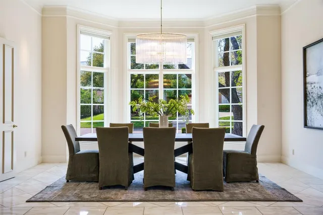 a view of a dining room with furniture windows and wooden floor