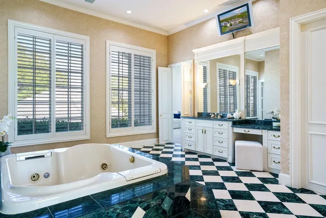 a bathroom with a bathtub a sink and a window