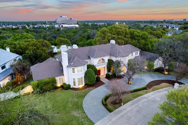 an aerial view of a house with garden space and street view
