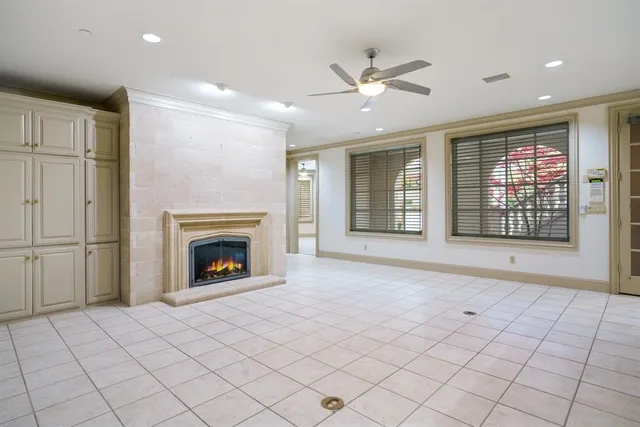a view of an empty room with a fireplace and a window