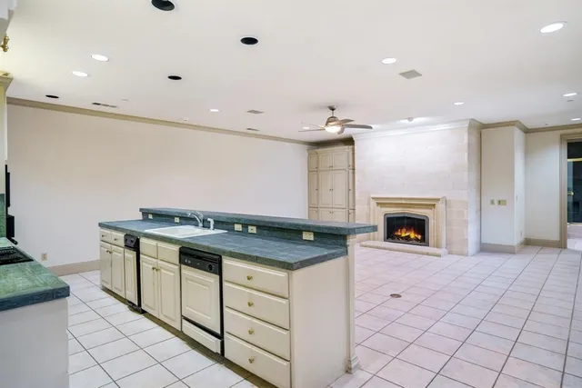 a kitchen with granite countertop a stove and a sink