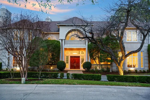 a front view of house with a garden
