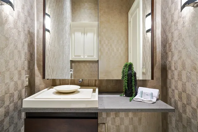 a kitchen with a sink and a mirror