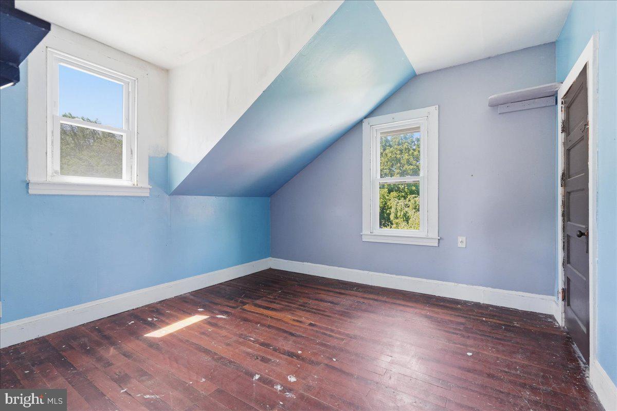 73 Church Road Arnold, MD 21012 - Photo 19 of 29 a view of an empty room with wooden floor and a window