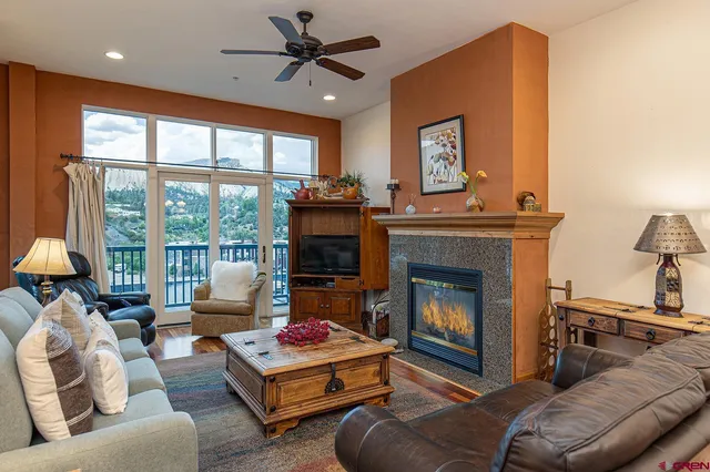 a living room with furniture and a fireplace