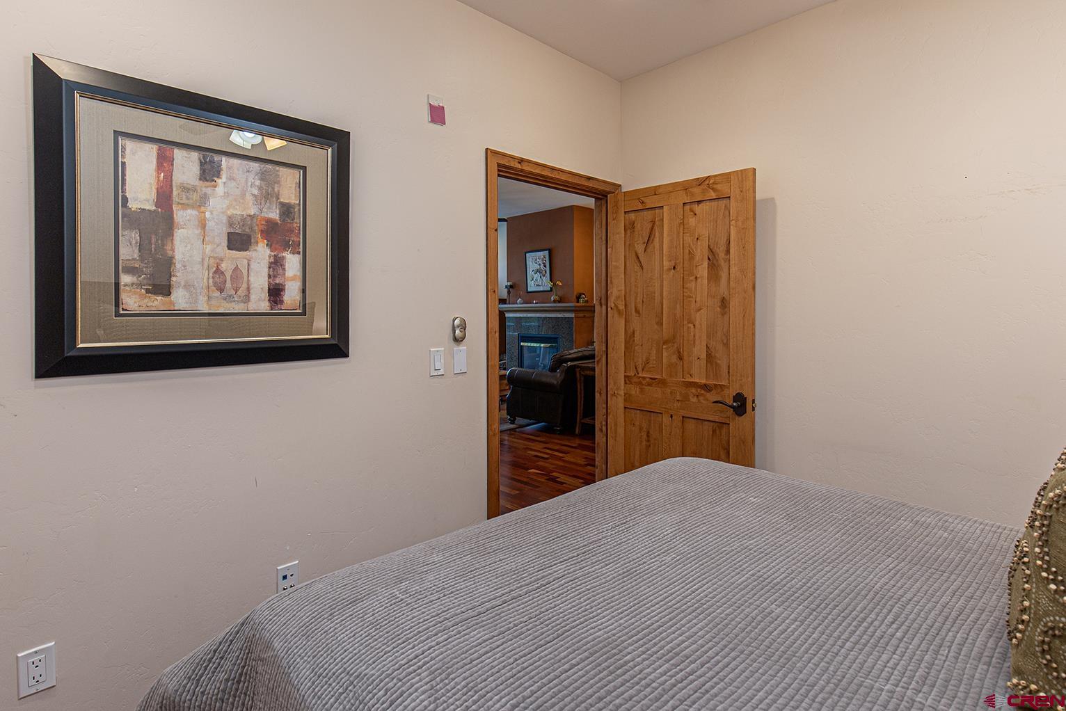 1099 Main Avenue, Unit 410 Durango, CO 81301 - Photo 13 of 34 a bedroom with a bed and wall painting