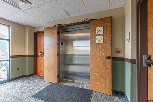 a view of a hallway with wooden shelves