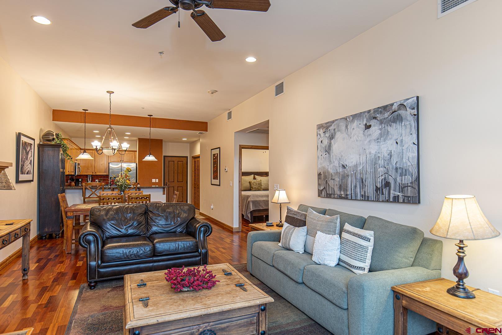 1099 Main Avenue, Unit 410 Durango, CO 81301 - Photo 3 of 34 a living room with furniture and a lamp
