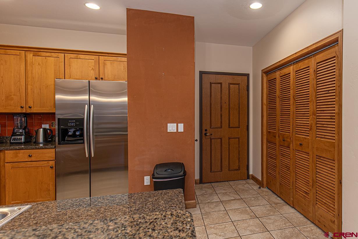 1099 Main Avenue, Unit 410 Durango, CO 81301 - Photo 8 of 34 a kitchen with stainless steel appliances granite countertop a refrigerator and a sink