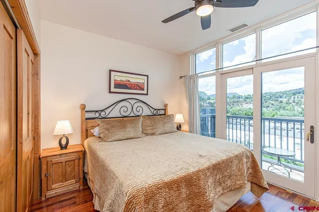 a bedroom with a large bed and a chandelier
