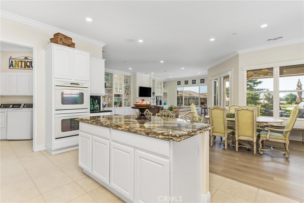 5233 Hampton Road Banning, CA 92220 - Photo 14 of 46 a kitchen with cabinets and chairs