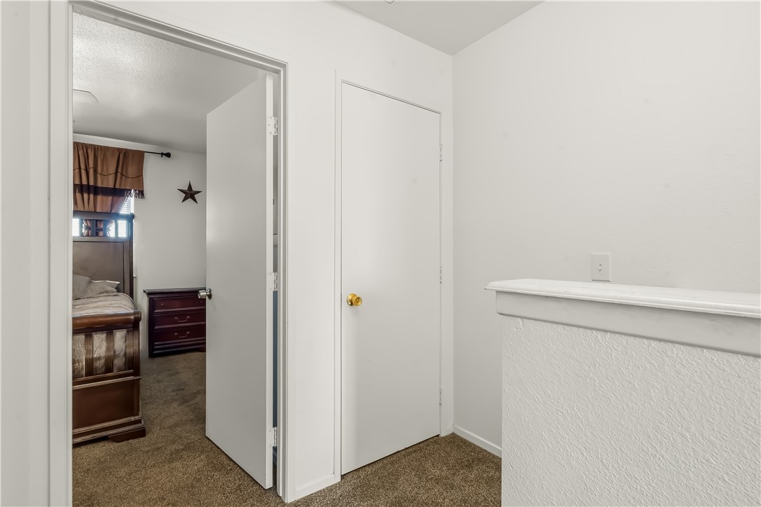 1666 Palma Road Bullhead City, AZ 86442 - Photo 15 of 22 Hallway with dark carpet