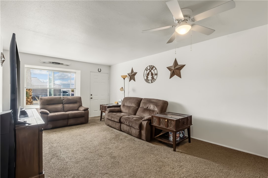 1666 Palma Road Bullhead City, AZ 86442 - Photo 7 of 22 Living room featuring carpet and ceiling fan