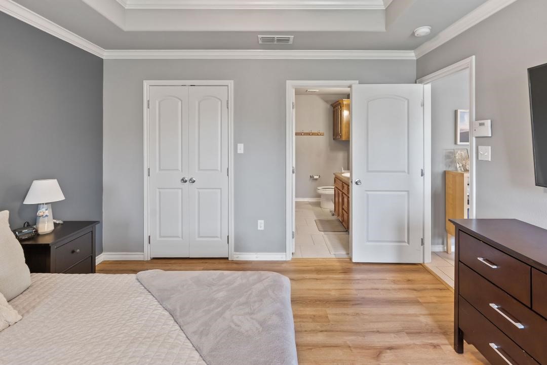 4328 Bratton Road Corpus Christi, TX 78413 - Photo 12 of 24 a bedroom with a bed and wooden floor