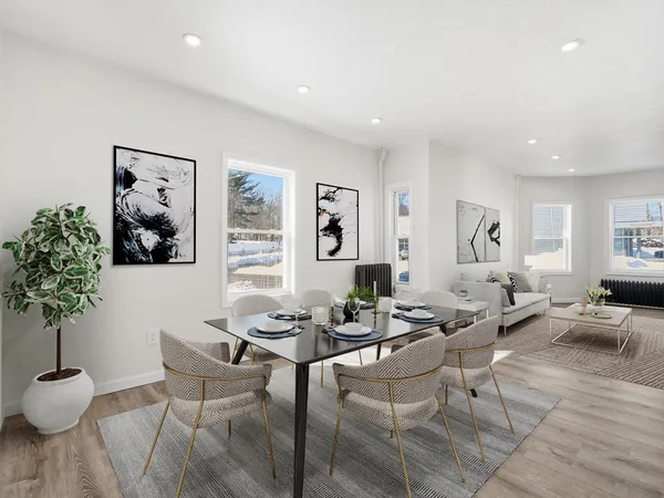 a living room with furniture potted plant and window