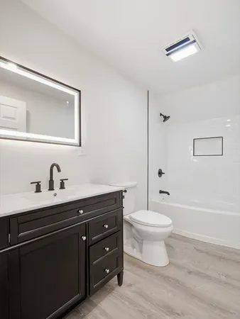 a bathroom with a toilet a sink and a bathtub