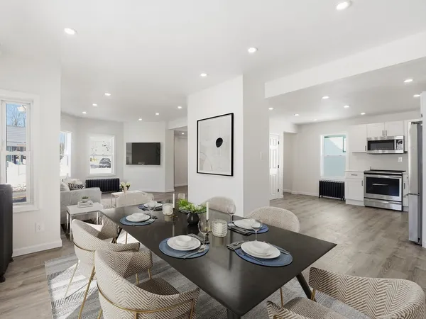 a dining room with furniture and a kitchen view