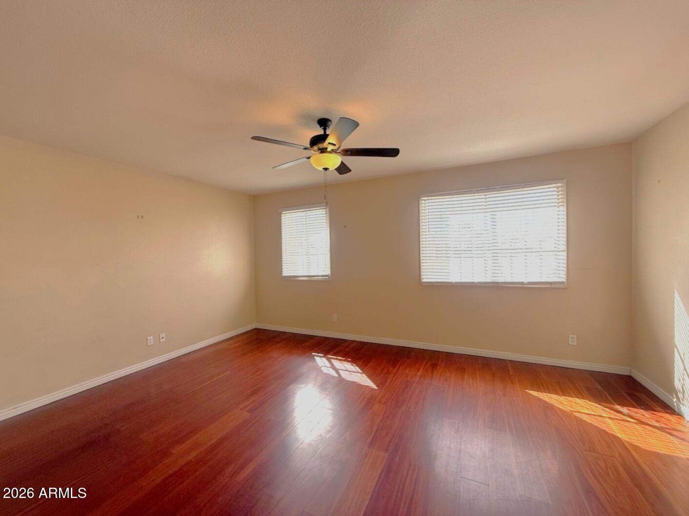 4625 South Rita Lane Tempe, AZ 85282 - Photo 6 of 16 a view of an empty room with wooden floor and a window