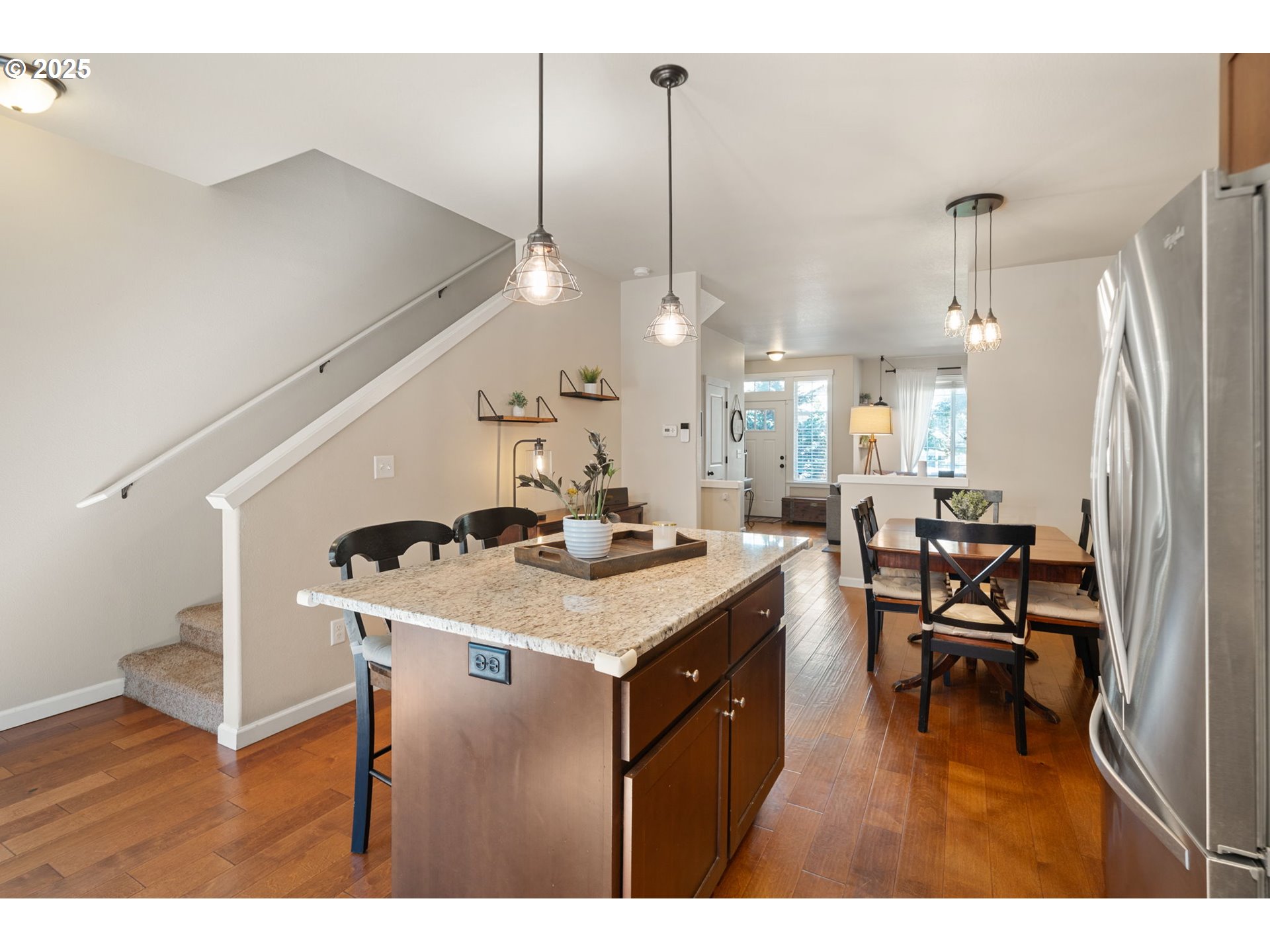 18292 Southwest Anna Mae Lane Beaverton, OR 97003 - Photo 14 of 34 a kitchen with a table chairs appliances and wooden floor