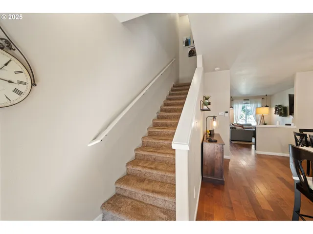 a living room with furniture stairs and a window