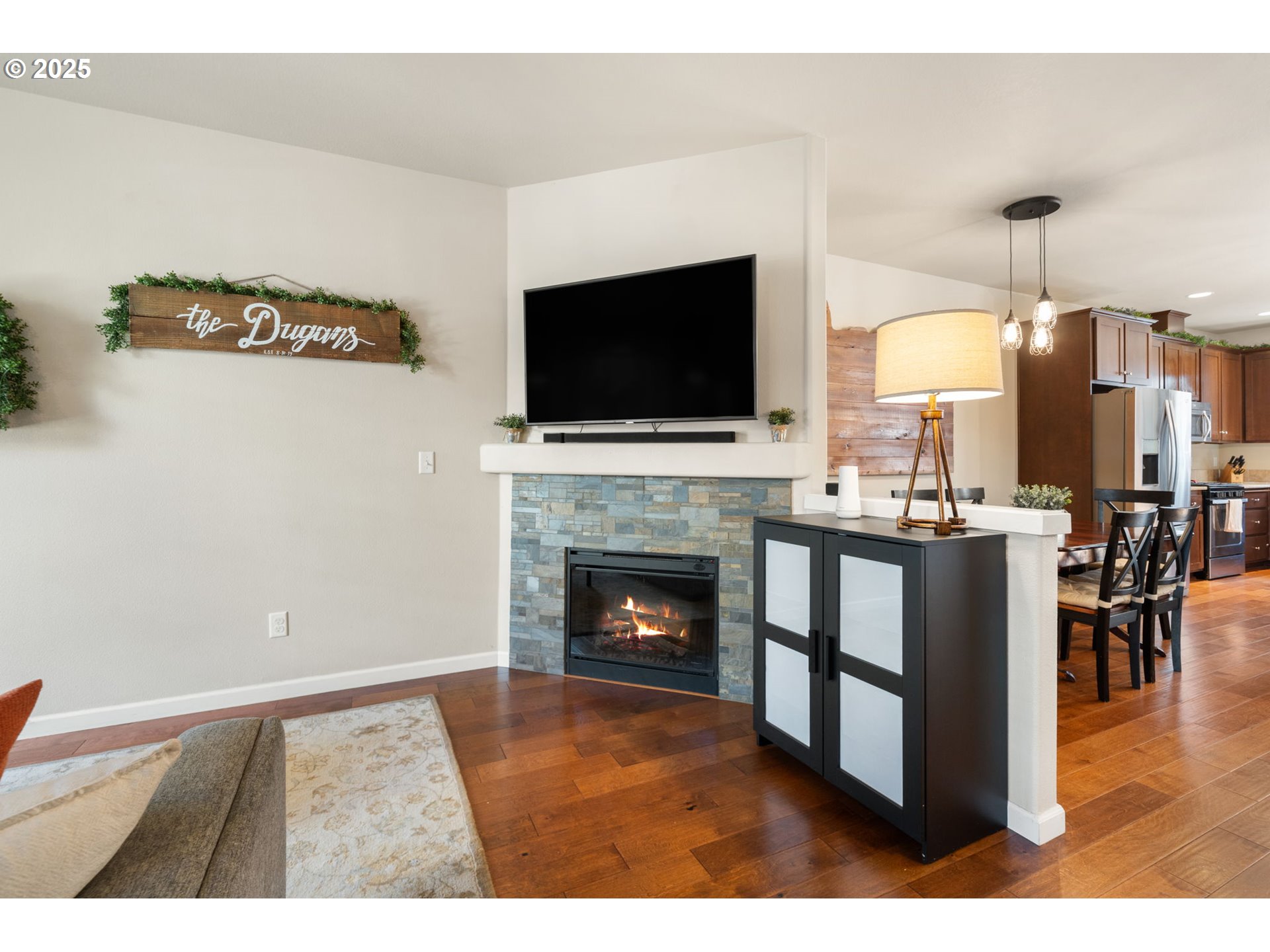 18292 Southwest Anna Mae Lane Beaverton, OR 97003 - Photo 8 of 34 a living room with furniture a flat screen tv and a fireplace