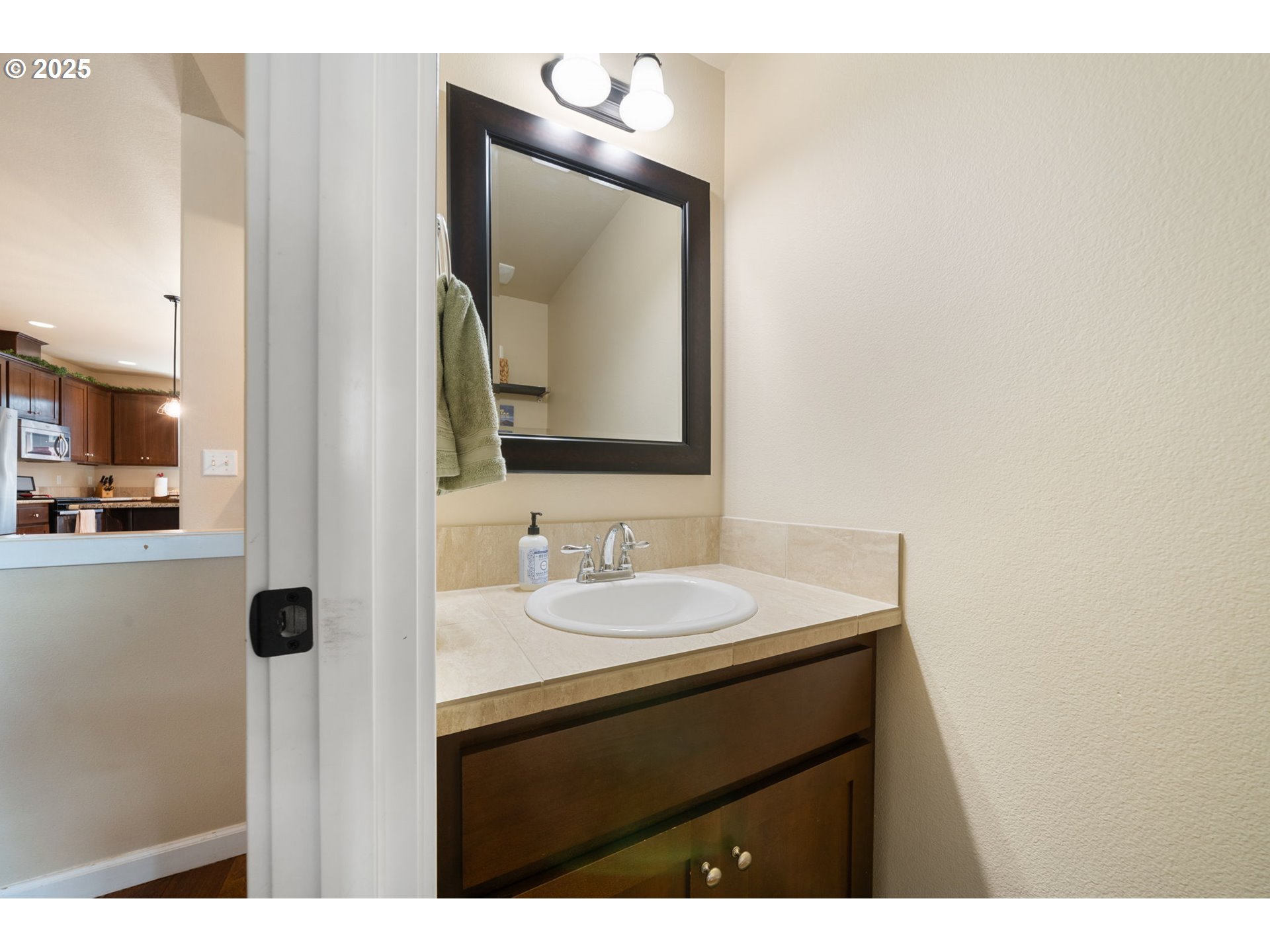 18292 Southwest Anna Mae Lane Beaverton, OR 97003 - Photo 9 of 34 a bathroom with a sink vanity and a mirror