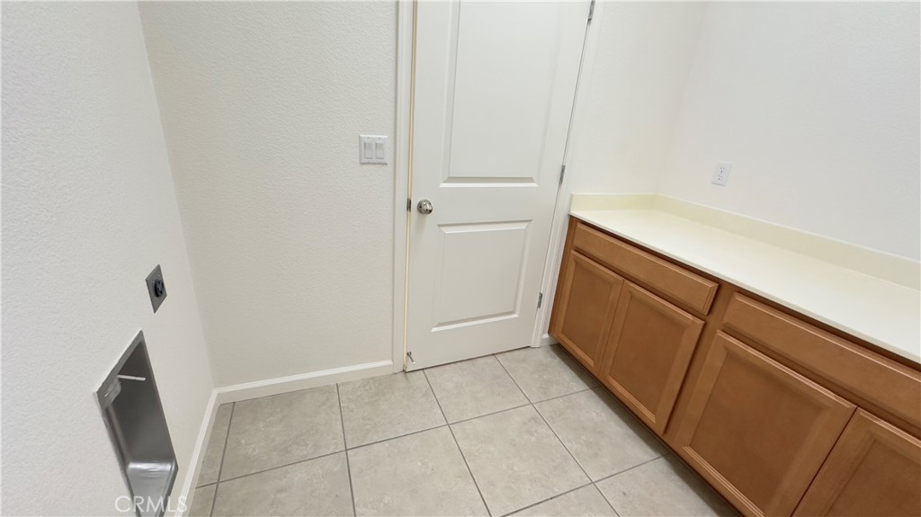 2428 Freestone Drive Merced, CA 95340 - Photo 17 of 18 Convenient indoor laundry room with built-in cabinetry and plenty of storage space