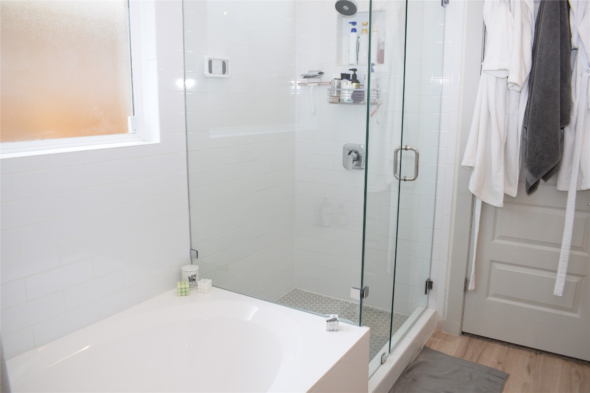 2409 Bear Cub Bend Leander, TX 78641 - Photo 15 of 37 a bathroom with a bathtub and a shower