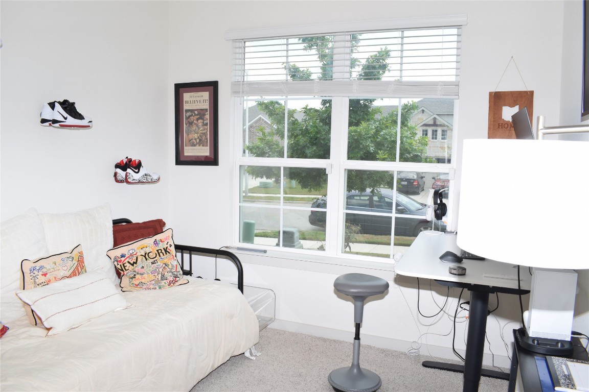 2409 Bear Cub Bend Leander, TX 78641 - Photo 17 of 37 a bedroom with furniture and a large window