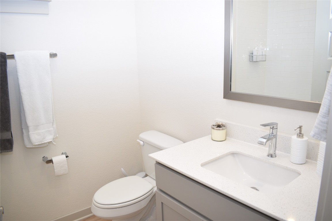 2409 Bear Cub Bend Leander, TX 78641 - Photo 18 of 37 a bathroom with a sink a toilet and mirror
