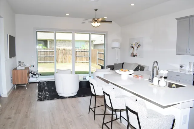 a dining room with wooden floor and a chandelier