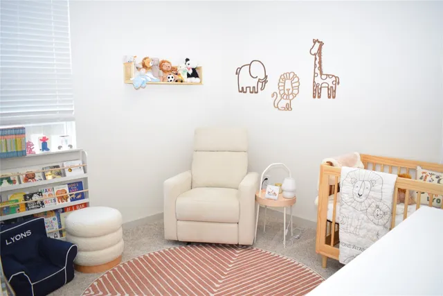 a bedroom with furniture and a large window