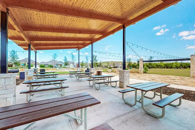 an aerial view of a house with swimming pool and outdoor seating