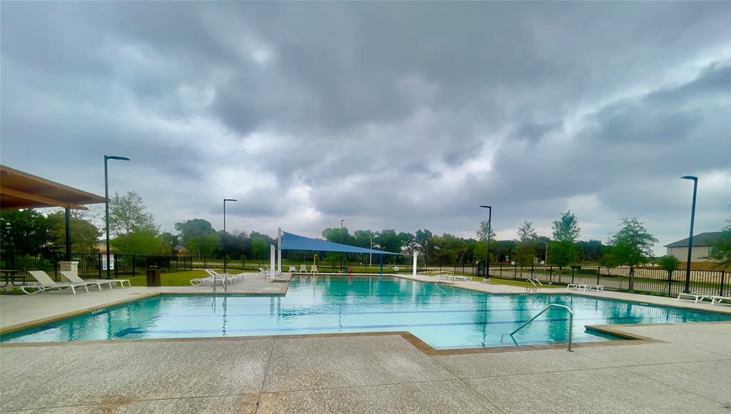 2409 Bear Cub Bend Leander, TX 78641 - Photo 30 of 37 a view of a swimming pool and a yard